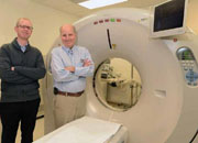 Picture of 2 doctors standing next to CT scanner